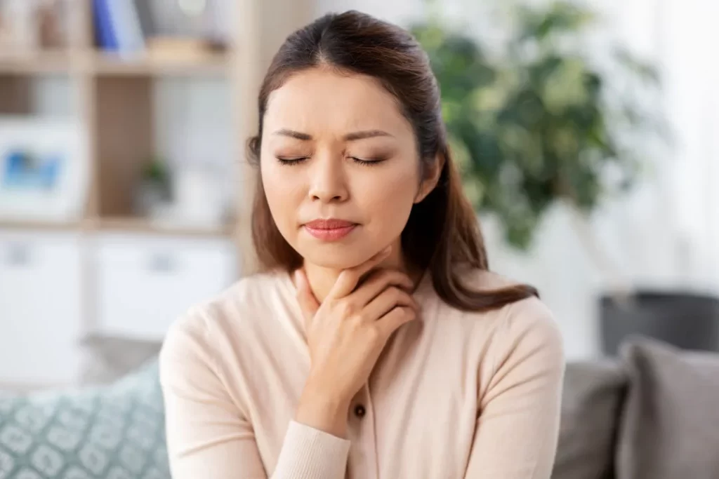 A woman suffering from sore throats.