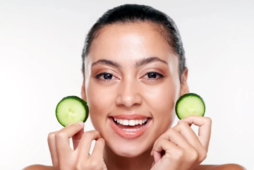 Cucumber is good for skin nourishment as shown by a girl.
