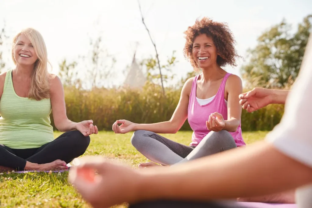 Ladies performing the yoga exercise. 