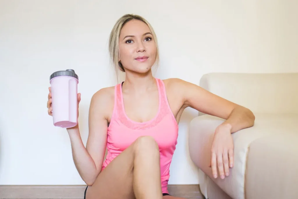 A lady having protein shake. 