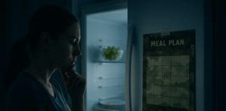What Really Happened When I Did the Military Diet for a Month: A Powerful Look at Results, Challenges, and Lessons Learned Woman contemplating in front of an open fridge at night with a camouflage meal plan, reflecting on how i did the military diet for a month.